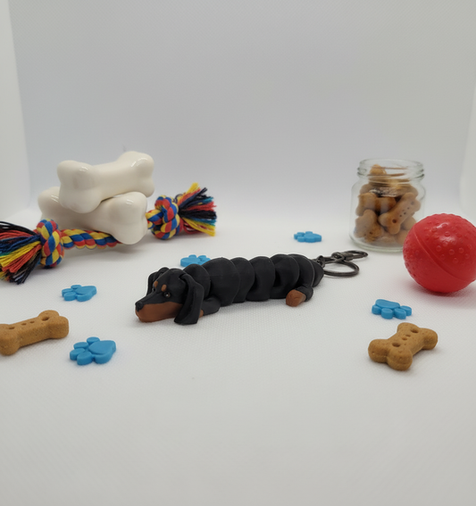 Articulated Dachshund keychain with professional dog-themed background